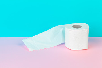 Toilet paper isolated on white table with blue background. Cleaning concept product