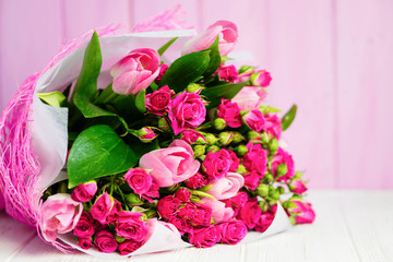 background beautiful bouquet of pink wild rose and pink tulip