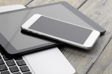 Open laptop with digital tablet and smartphone close up