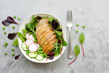 Baked turkey with salad and vegetables. Gray background, top view