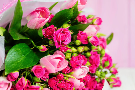 background beautiful bouquet of pink wild rose and pink tulip
