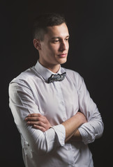 Beautiful fashion man in a suit and a butterfly