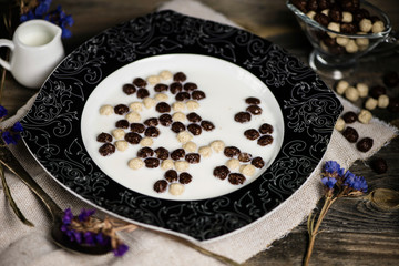 cereal breakfast with milk on old wooden background