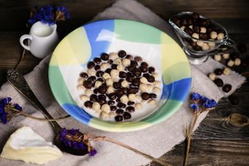 cereal breakfast with milk on old wooden background