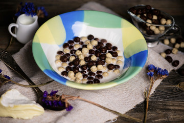 cereal breakfast with milk on old wooden background