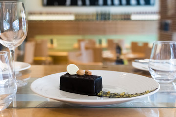 Selection of desserts, in a restaurant setting, with blurred background