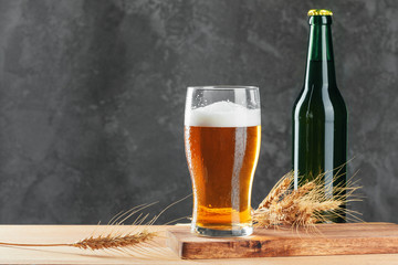 Single beer glass close up on dark stone background