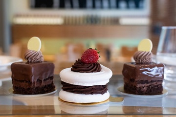 Selection of desserts, in a restaurant setting, with blurred background