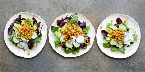Vegan Tortilla Chickpea Avocado Salad Cucumber and Yogurt Sauce. Healthy clean eating food concept....