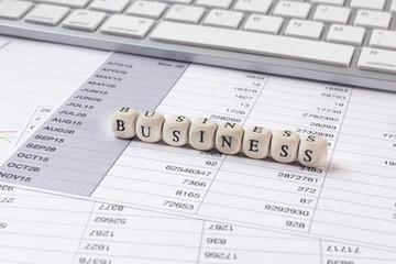 Fototapeta premium The Business word on wood cube business content image.