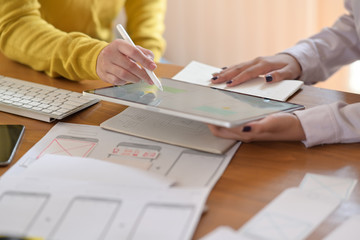 UI designer with website development team sketching wireframe smart phone layout