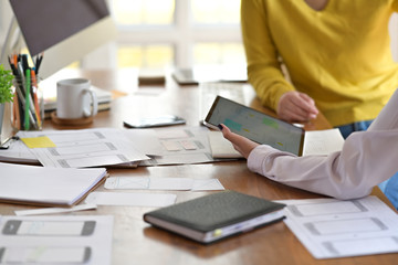 UI designer with website development team sketching wireframe smart phone layout