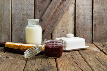 breakfast, cherry jam, milk bottle, slice of bread, old wood table