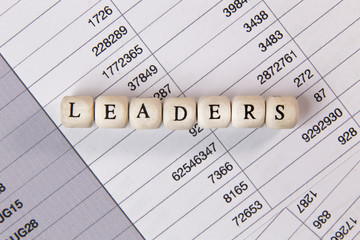 The leaders word on wood cube business content image.