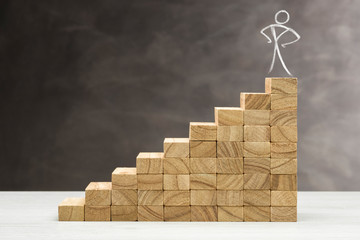 Concept of growth. Graphic with wooden steps on grey background, with human shape on top.