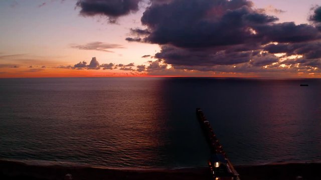 Beautiful sunrise with the clouds and the pier in Florida.
