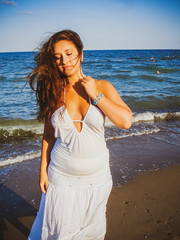 Plus size hispanic woman at sea. Young woman with overweight at vacation	 