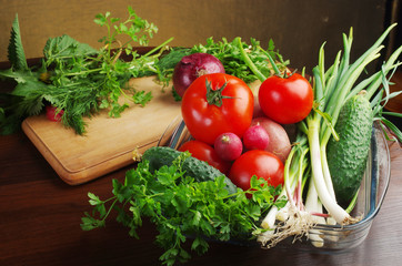 Appetizing vegetables and greens on the kitchen board