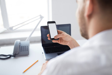 business, communication and technology concept - close up of businessman using smartphone at office