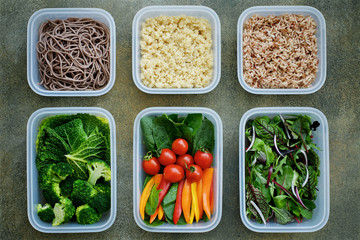  Vegan meal prep lunch box containers with quinoa, brown rice, buckwheat noodles, spinach, tomato, pepper, broccoli, savoy cabbage, lettuce, onions