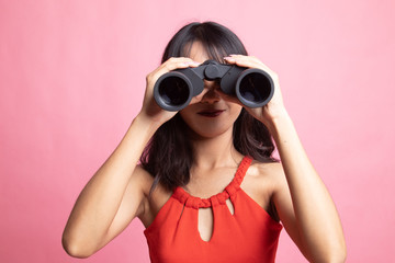 Young Asian woman with binoculars.