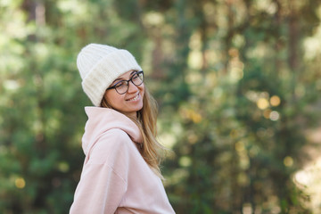 Young cheerful woman in glasses in the park