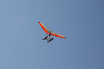 Powered hang glider, para glider. sail flying object on beautiful blue sky
