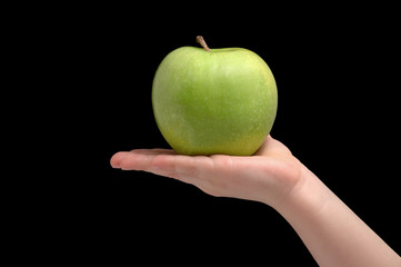 Green ripe apple on woman palm