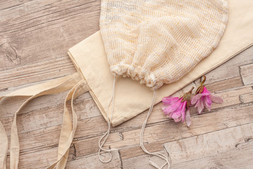Natural, plastic free recycled textile produce bag for carrying fruit or vegetables on a wooden...