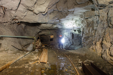 Undeground gold mine tunnel drift with miner