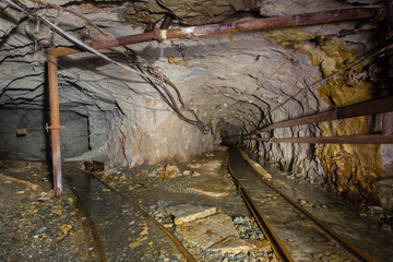 Naklejka premium Undeground gold mine tunnel drift with rails