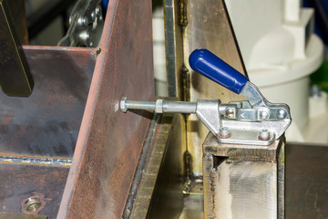 close up manual quick clamp of jig fixture for robot welding at factory