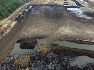 Stripping of a fertile layer of soil by excavator for sale. The land market in Ukraine.Drone aerial view. Near Kiev,Ukraine