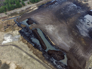 Stripping of a fertile layer of soil by excavator for sale. The land market in Ukraine.Drone aerial view. Near Kiev,Ukraine