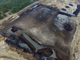 Stripping of a fertile layer of soil by excavator for sale. The land market in Ukraine.Drone aerial view. Near Kiev,Ukraine