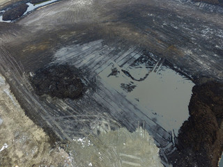 Stripping of a fertile layer of soil by excavator for sale. The land market in Ukraine.Drone aerial...