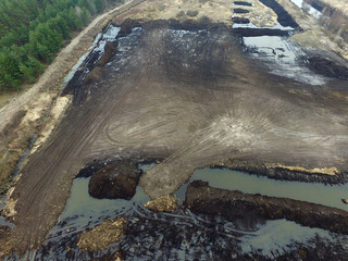 Stripping of a fertile layer of soil by excavator for sale. The land market in Ukraine.Drone aerial view. Near Kiev,Ukraine