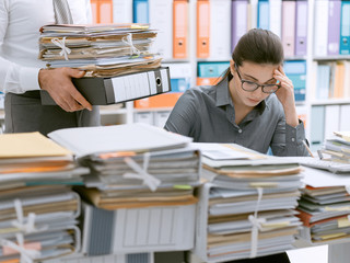 Young secretary overwhelmed by work
