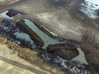 Stripping of a fertile layer of soil by excavator for sale. The land market in Ukraine.Drone aerial view. Near Kiev,Ukraine