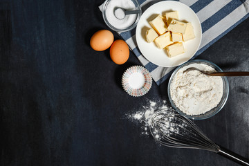 Ingredients for baking of cookies - flour, eggs, spices, vanilla, butter, sugar. Top view, copy space. Food background