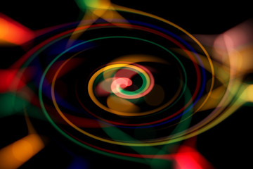 Blurred abstract background. Image of red, blue, green and yellow circles and wavy lines of different sizes.