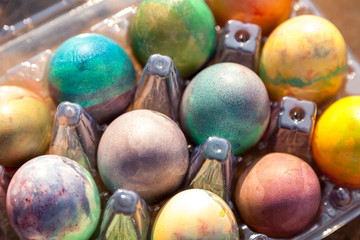 Group of Easter colored eggs in plastic container