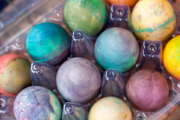 Fototapeta na wymiar Group of Easter colored eggs in plastic container
