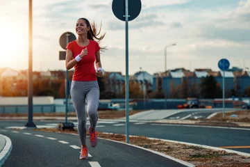 Rolgordijnen Young  woman jogging outdoors © ivanko80