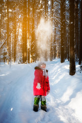 Girl is walking on a winter day in the forest