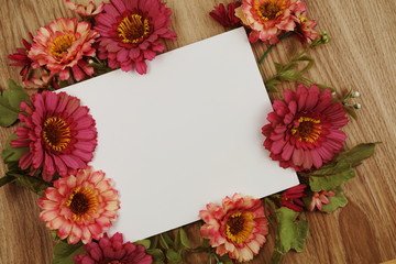 Flat lay of flowers and space copy on wooden background