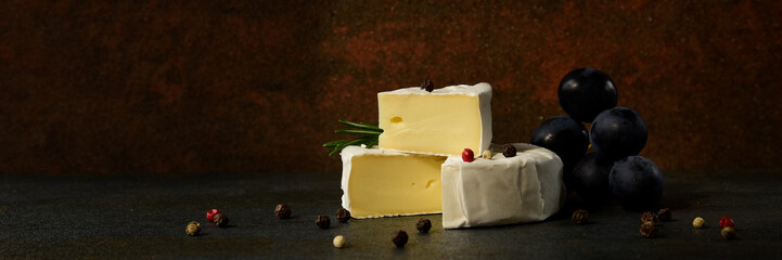Cheese camembert or brie with dark grapes