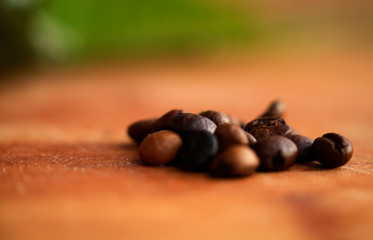 Closeup of coffee beans at roasted coffee heap. Coffee bean on macro ground coffee background. Arabic roasting coffee - ingredient of hot beverage