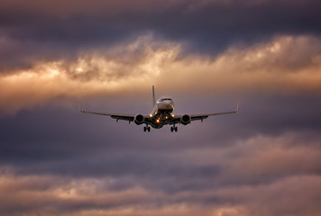 Naklejka na ściany i meble Plane on final approach with wheels down and dramatic sky, palma airport, mallorca, spain.