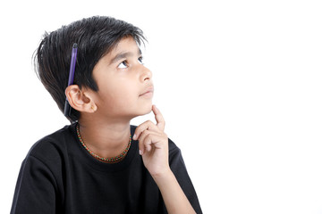 Cute Indian boy thinking idea and looking at up, isolated on white background 